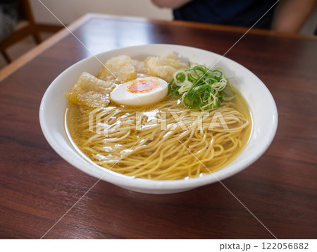 スープが透明で金色の塩ラーメン。茹で卵とネギとお麩トッピング。 122056882