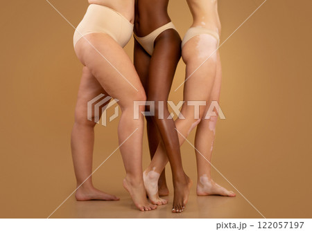 Every Body Is Beautiful. Tree women with different race and body sizes posing in underwear over beige background, cropped image with free space 122057197