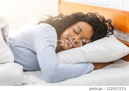 Cozy bedtime. Peaceful pretty african woman sleeping in bed at home Cozy bedtime. Peaceful pretty african woman sleeping in bed at home 122057213