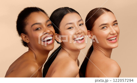 Skin And Body Care. Three Multiethnic Women Posing Smiling To Camera Standing Over White Background. Studio Shot, Panorama 122057294