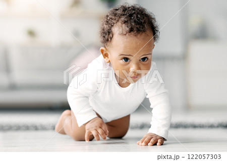 Closeup Portrait Of Cute Little Black Infant Baby Crawling On Floor At Home, Adorable African American Toddler Child Wearing Bodysuit Discovering Living Room, Selective Focus, Free Space Closeup Portrait Of Cute Little Black Infant Baby Crawling On Floor At Home, Adorable African American Toddler Child Wearing Bodysuit Discovering Living Room, Selective Focus, Free Space 122057303
