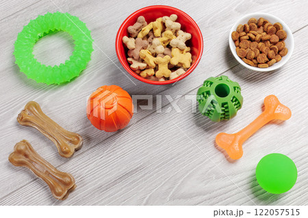 Pet supplies and playful items including dry food and toys for dogs. 122057515