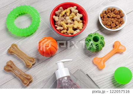 Pet supplies and playful items including a training pad, shampoo, dry food and toys for dogs. Pet supplies and playful items including a training pad, shampoo, dry food and toys for dogs. 122057516