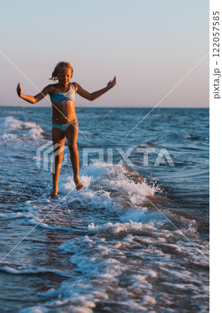 The moment of jumping over the oncoming wave The moment of jumping over the oncoming wave 122057585