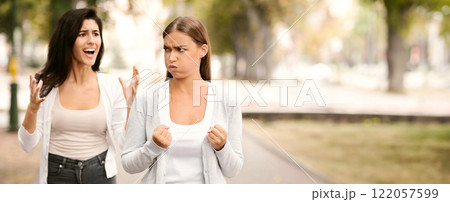 Quarrel. Two Emotional Girls Friends Having Conflict Walking In Park Outdoor. Selective Focus 122057599