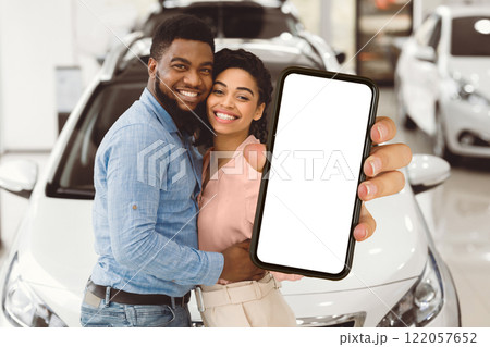 New Automobile. Cheerful Spouses Posing Hugging And Holding New Car Key In Dealership Showroom. 122057652