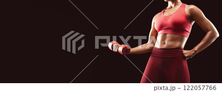 Fitness concept. Cropped of strong black woman pumping iron over black background, using fitness barbell, empty space Fitness concept. Cropped of strong black woman pumping iron over black background, using fitness barbell, empty space 122057766