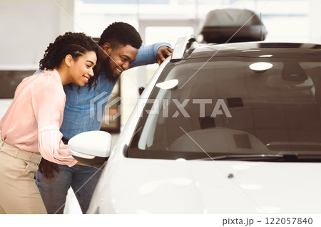 New Car. Black Husband And Wife Choosing New Auto Together In Dealership Store. Copy Space New Car. Black Husband And Wife Choosing New Auto Together In Dealership Store. Copy Space 122057840