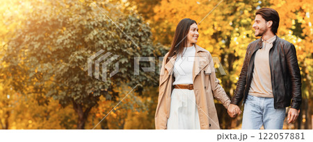 Together forever. Loving beautiful smiling couple spending time at autumn forest 122057881