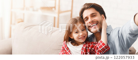 Positive portrait of father and little daughter taking selfie at home, free space Positive portrait of father and little daughter taking selfie at home, free space 122057933