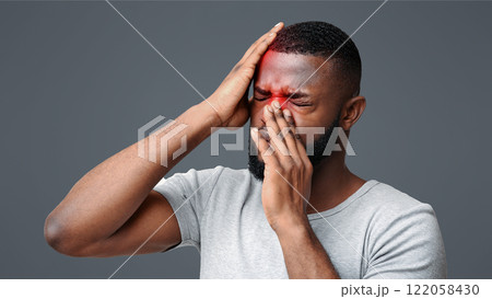 Sick black man having pain in forehead and nose, suffering from antritis 122058430