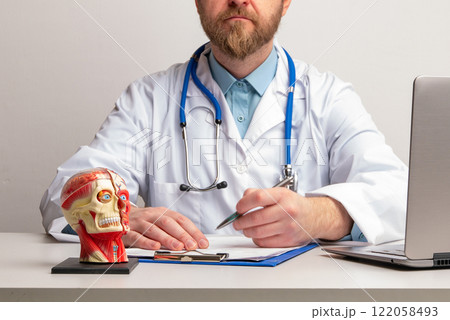 Doctor Hand with pen over cervical vertebrae of human head model. Neck pain, stiffness concept with red point. Arthritis, pinched nerve, strain. High quality photo Doctor Hand with pen over cervical vertebrae of human head model. Neck pain, stiffness concept with red point. Arthritis, pinched nerve, strain. High quality photo 122058493