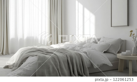 The image shows a minimalist bedroom with a white bed. The bed has a gray throw blanket on top of the white linens 122061253
