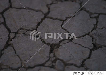 Cracked and Dry Land Surface Texture Represents a Parched Environment and Barren Landscape Cracked and Dry Land Surface Texture Represents a Parched Environment and Barren Landscape 122061589