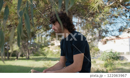 Sad Pensive Long Haired Boy Sitting in a Park Crying for the Mistakes He Made Sad Pensive Long Haired Boy Sitting in a Park Crying for the Mistakes He Made 122063967
