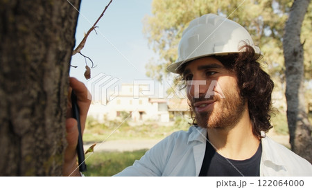 Scientist Fascinated By The Beautiful Trunk Of A Tree In The Countryside Scientist Fascinated By The Beautiful Trunk Of A Tree In The Countryside 122064000