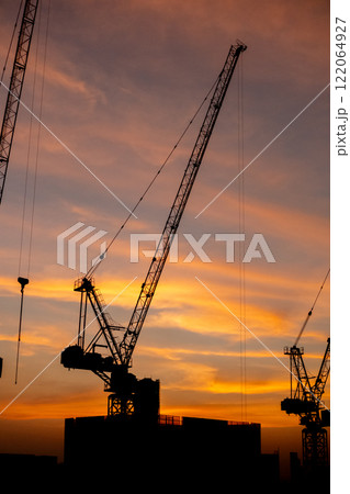 Silhouette of construction crane with beautiful sunset sky. Silhouette of construction crane with beautiful sunset sky. 122064927