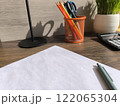 cozy home office desk with a white sheet of paper and plants. High quality photos 122065304