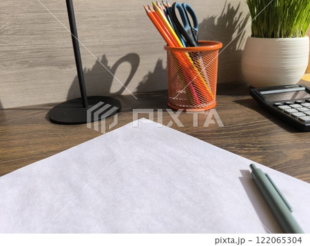 cozy home office desk with a white sheet of paper and plants. High quality photos cozy home office desk with a white sheet of paper and plants. High quality photos 122065304
