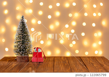christmas tree, clock, sledge, snowman, candles, gifts on a wooden background and lights background christmas tree, clock, sledge, snowman, candles, gifts on a wooden background and lights background 122065799
