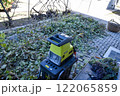Autumn work in gardening, pruning and crushing branches, wood, in a shredder and mulcher 122065859