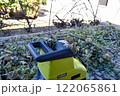 Autumn work in gardening, pruning and crushing branches, wood, in a shredder and mulcher 122065861