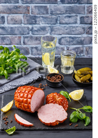 boneless smoked ham on black slate board, top view 122066409