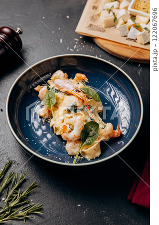 Gourmet shrimp pasta in creamy sauce, beautifully plated for an indulgent dining experience 122067696