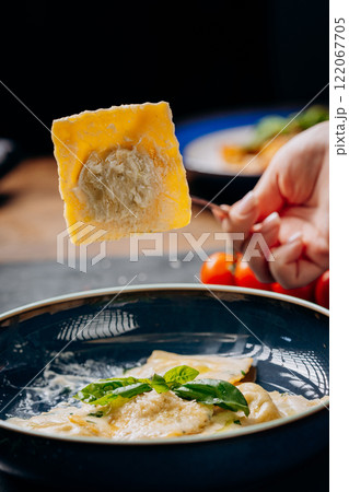 Fork lifting creamy basil ravioli, a perfect Italian gourmet dish for elegant food photography Fork lifting creamy basil ravioli, a perfect Italian gourmet dish for elegant food photography 122067705