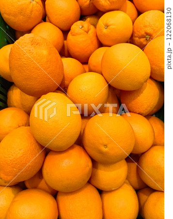 Freshly harvested oranges piled high in a vibrant display at the local market 122068130