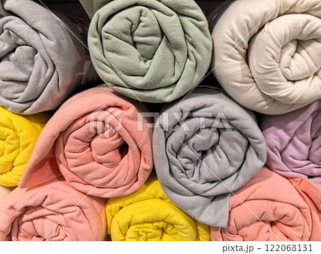 Colorful rolled blankets stacked neatly in a cozy home decor shop display Colorful rolled blankets stacked neatly in a cozy home decor shop display 122068131