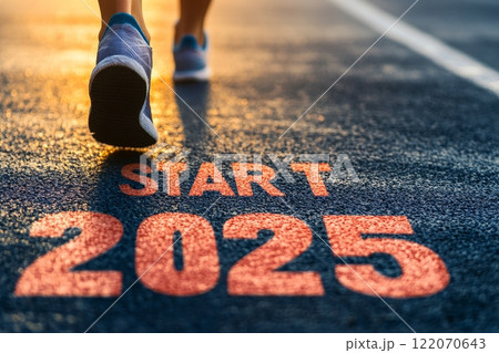Running towards the start of 2025 on a sunlit track. 122070643