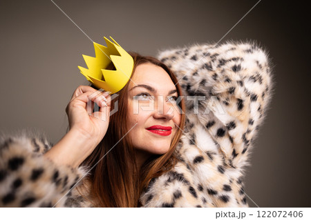 A Confident Woman Adorned with a Crown, Dressed in a Fashionable and Stylish Outfit 122072406