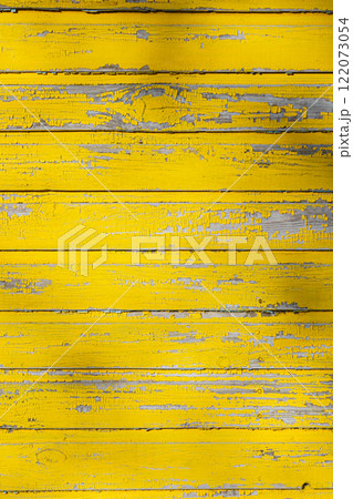 A backdrop of vibrant yellow weathered wood panels creates an appealing aesthetic for various uses A backdrop of vibrant yellow weathered wood panels creates an appealing aesthetic for various uses 122073054