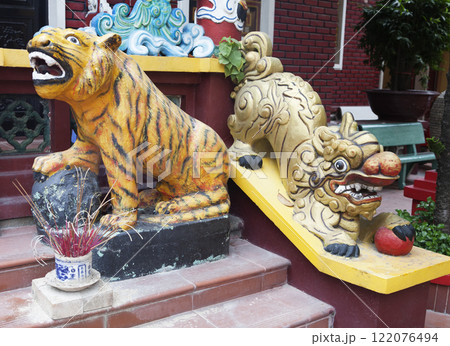 Tiger and lion statues at the entrance of a temple Tiger and lion statues at the entrance of a temple 122076494