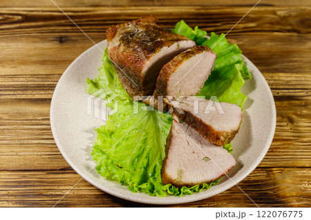 Tasty baked pork with spices on a wooden table 122076775