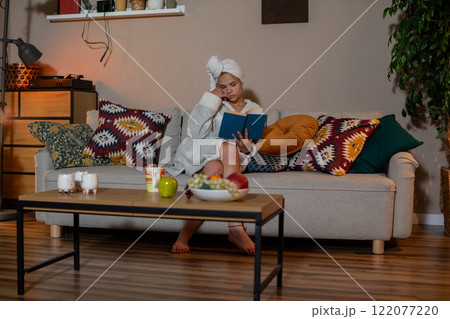 Enjoy cozy indoor relaxation with a book and refreshing drinks for perfect leisure 122077220