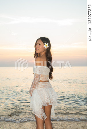 Beautiful Young Thai Woman at Tropical Beach During Sunset Beautiful Young Thai Woman at Tropical Beach During Sunset 122077276