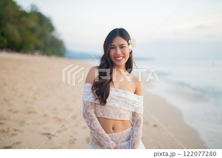 Beautiful Young Thai Woman at Tropical Beach During Sunset 122077280