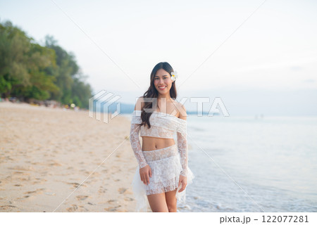 Beautiful Young Thai Woman at Tropical Beach During Sunset Beautiful Young Thai Woman at Tropical Beach During Sunset 122077281