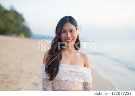 Beautiful Young Thai Woman at Tropical Beach During Sunset Beautiful Young Thai Woman at Tropical Beach During Sunset 122077282