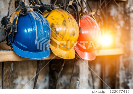 Safety First: Colorful Hard Hats Ready for Teamwork on a Construction Site 122077413