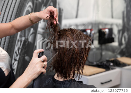 Experience a Hair Salon Treatment featuring an Expert Stylist skillfully at work in action 122077736