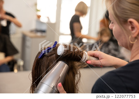 Mastering Hair Styling Techniques with a Blow Dryer and a Round Brush for Beautiful Results 122077753
