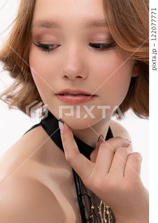 An Elegant Young Woman Featuring a Stylish Makeup Look and Beautifully Styled Hairstyle An Elegant Young Woman Featuring a Stylish Makeup Look and Beautifully Styled Hairstyle 122077771