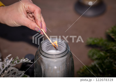 Lighting a Candle in a Serene Moment of Deep Reflection and Personal Contemplation 122078319