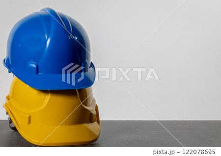 Various Colorful Construction Helmets Arranged Neatly on a Table for Easy Access and Use Various Colorful Construction Helmets Arranged Neatly on a Table for Easy Access and Use 122078695