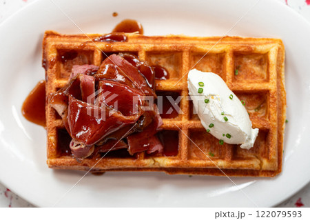 Portion of waffle with brisket and cream cheese 122079593
