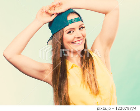 Woman casual style cap on head on blue. Fashion shot Woman casual style cap on head on blue. Fashion shot 122079774