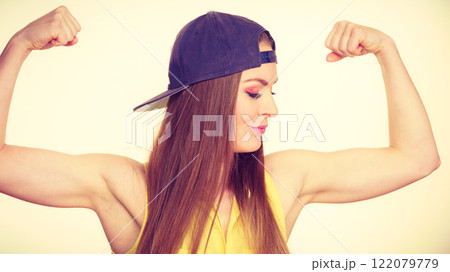 Woman casual style showing off muscles biceps Woman casual style showing off muscles biceps 122079779